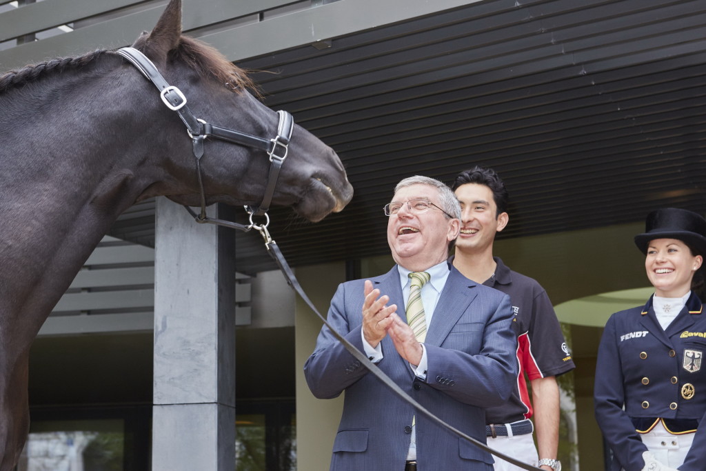 Straight from the horse's mouth: International Olympic Committee President Thomas Bach was greeted at Fédération Equestre Internationale (FEI) Headquarters by the stallion Sarango after meetings with an FEI delegation headed by President Ingmar De Vos and Secretary General Sabrina Zeender. Also pictured are Eventing athlete Alex Hua Tian (CHN) and German Dressage athlete Kristina Bröring-Sprehe. Brazilian Jumping athlete Pedro Veniss (out of shot) also met with the IOC President. (Liz Gregg/FEI)