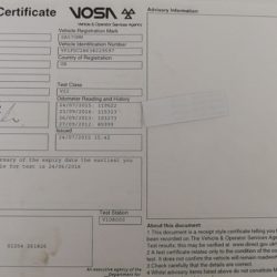 The MOT certificate with the true mileage history, as shown by the flap of paper folded back.