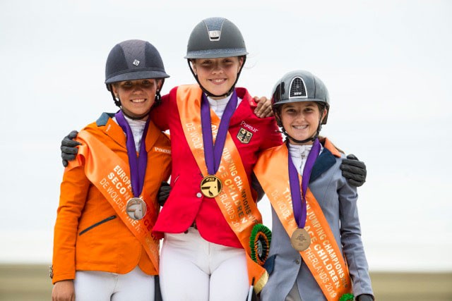 On the podium for the Children's Championship at the FEI Jumping European Championships for Children, Juniors and Young Riders 2019 at Zuidwolde (NED) - (L to R) The Netherlands' Emma Bocken (silver) , Germany's Tiara Bleicher (gold) and Bulgaria's Aya Miteva (bronze). (FEI/Leonjo de Koster)
