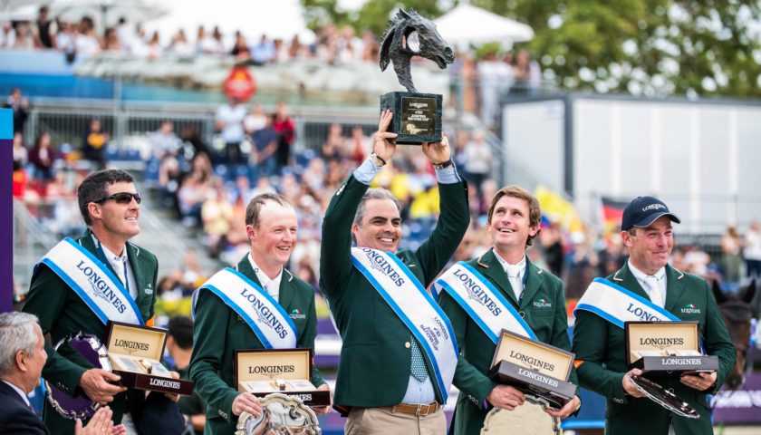 Chef d’Equipe Rodrigo Pessoa holds the trophy aloft as Team Ireland celebrate victory at the Longines FEI Jumping Nations Cup™ Final 2019 in Barcelona (ESP). (FEI/Lukasz Kowalski)