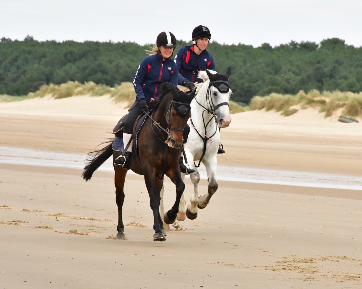 Georgie and Edward ride into Holkham beach - CREDIT Veale Family