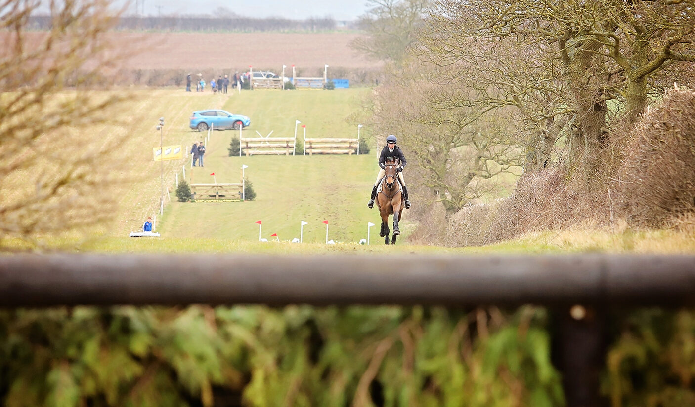 Livestream Burnham Market International - Horse rider galloping up hill