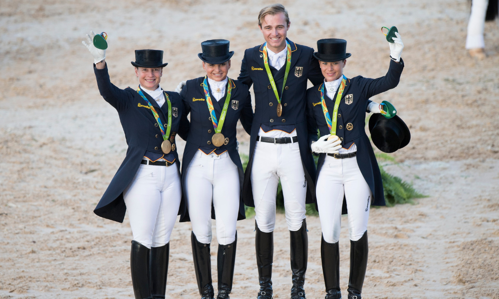 Celebrating Germany’s 13th Olympic Dressage team gold at the Rio 2016 Olympic Games: (L to R) Isabell Werth, Dorothee Schneider, Sönke Rothenberger and Kristina Bröring-Sprehe. (FEI/Richard Juilliart)