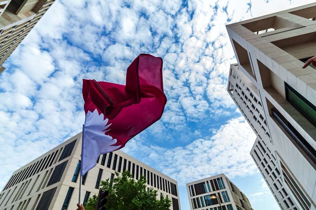 Horse Racing in Qatar image of country flag Photo by Rowen Smith on Unsplash