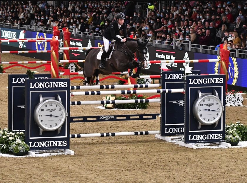 London International Horse Show 2022 a horse and rider jumping over a Longines sponsored jump during the 2021 event