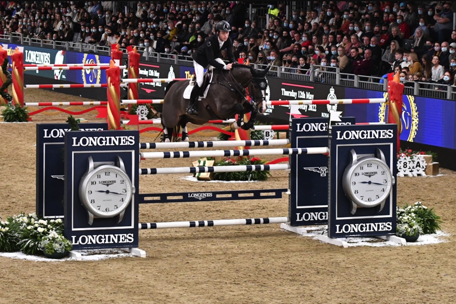 London International Horse Show 2022 a horse and rider jumping over a Longines sponsored jump during the 2021 event