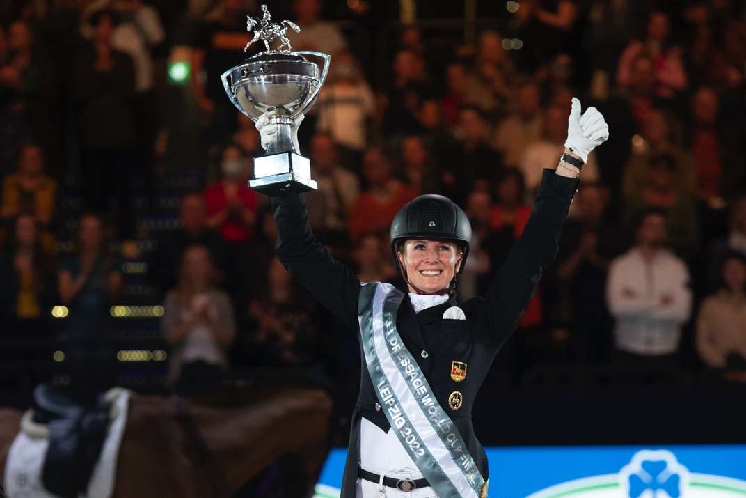 Germany’s Jessica von Bredow-Werndl holds the winner’s trophy aloft after victory with TSF Dalera BB in today’s Freestyle at the FEI Dressage World Cup™ Final 2022 in Leipzig, Germany. (FEI/Richard Juilliart)