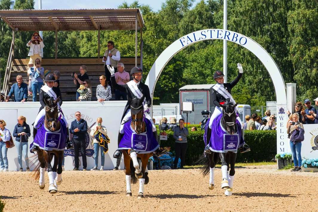 Team Denmark doing the lap of honour after winning the Nations Cup from left Nadja Aaboe Sloth riding Favour Gersdorf, Daniel Bachmann Andersen riding Zippo M.I. and Nanna Skodborg Merrald riding Blue Hors St Schufro. (FEI/Leanjo de Koster)