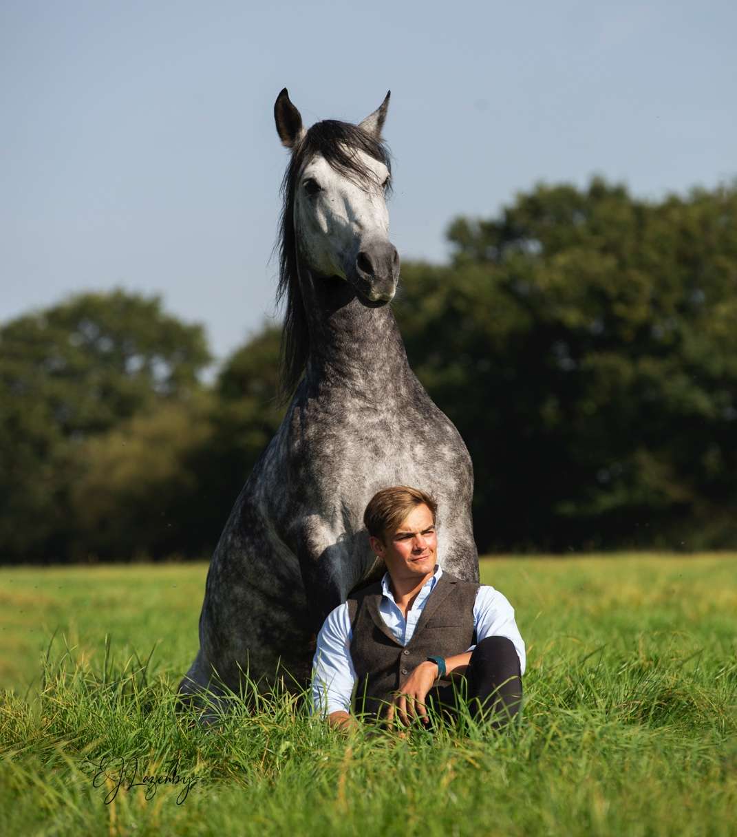 Ben Atkinson with a dapple grey horse sat together in the field