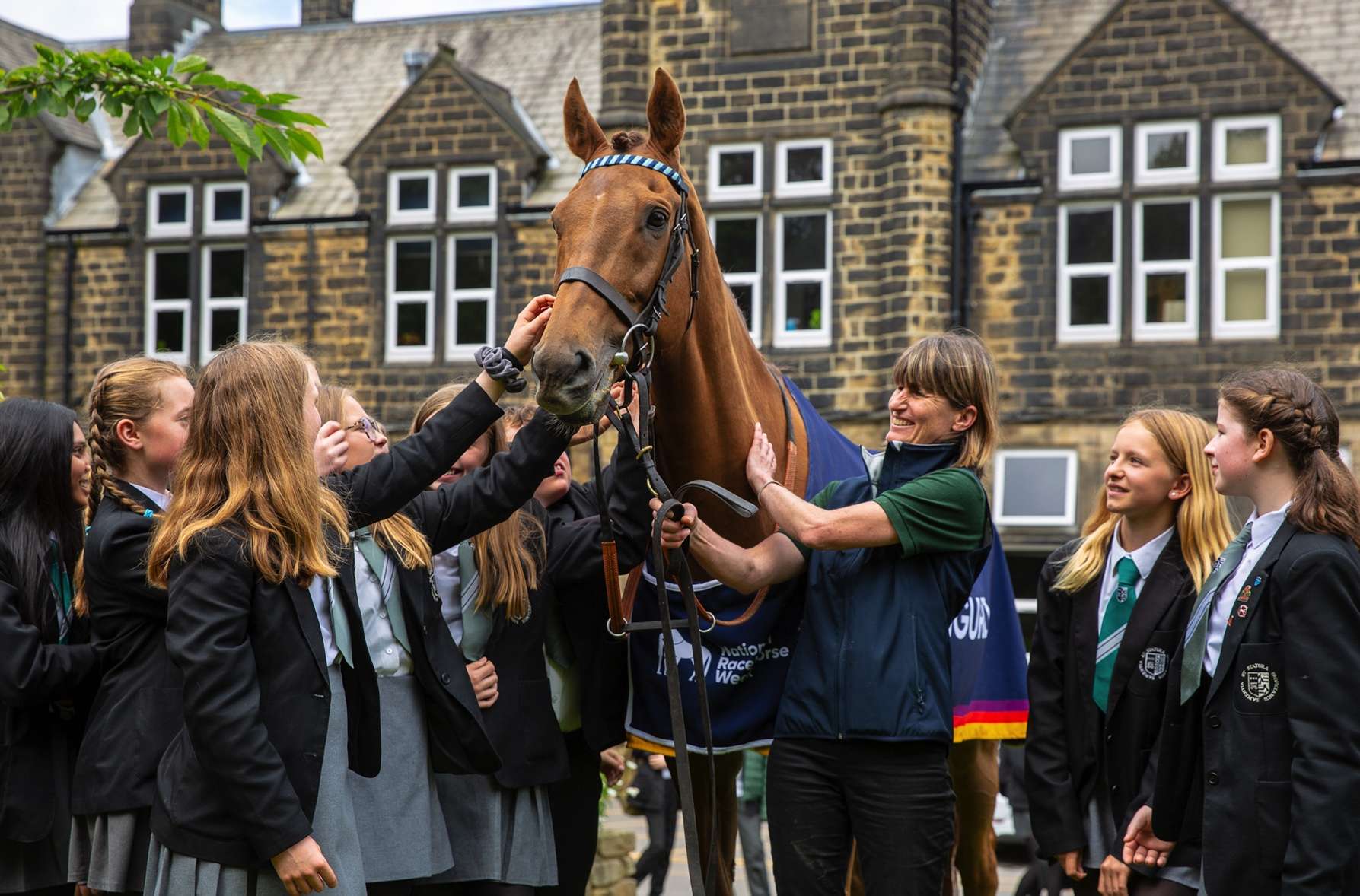 A racehorse with school children. National Racehorse Week will include visits to schools and other community organisations 