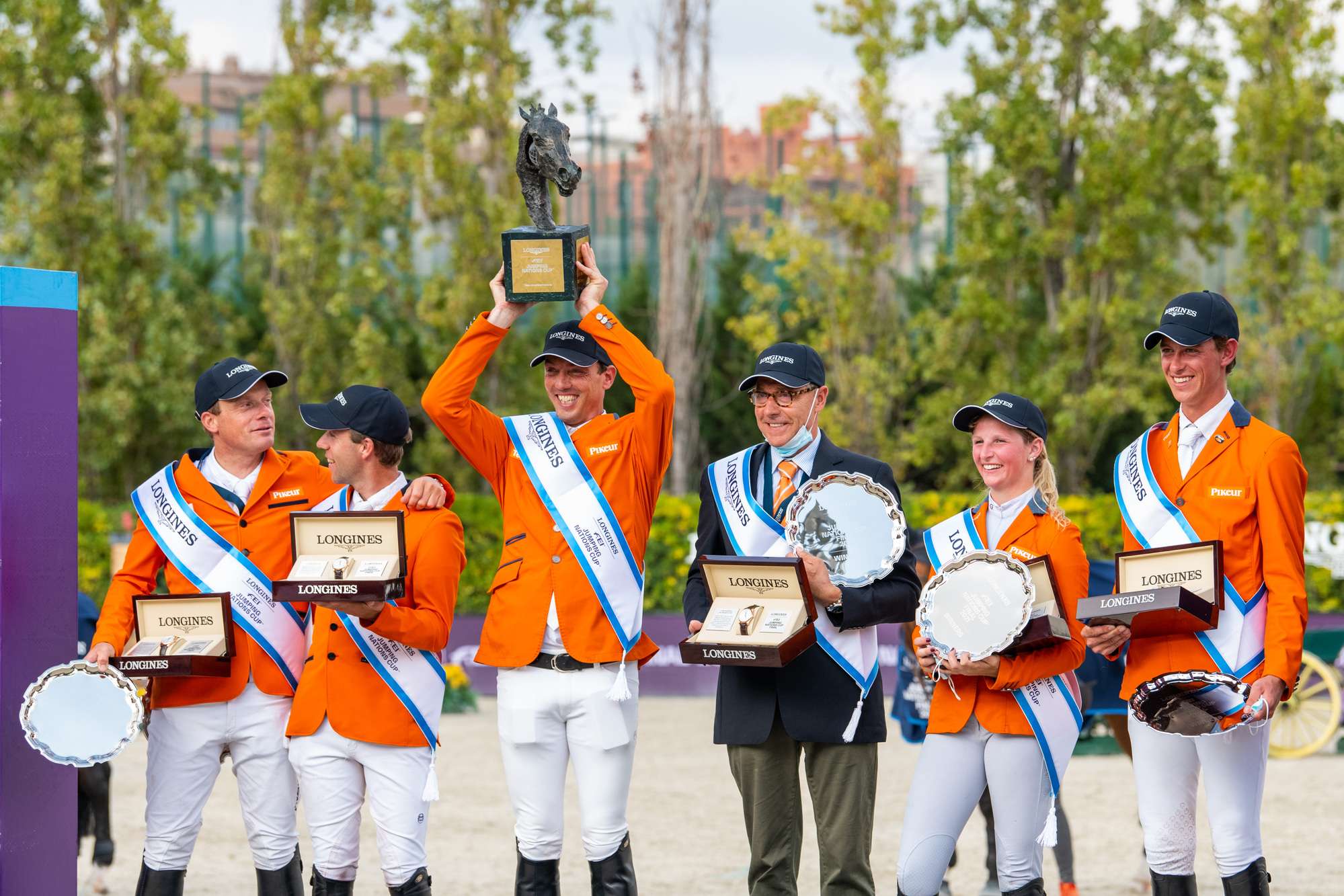 The Dutch champions on the podium at the Longines FEI Jumping Nations Cup™ 2021 Final at the Real Club de Polo in Barcelona, Spain - (L to R) Willem Greve, Maikel van der Vleuten, Harrie Smolders, Rob Ehrens (Chef dEquipe), Sanne Thijssen and Kevin Jochems. (FEI/Lukasz Kowalski)