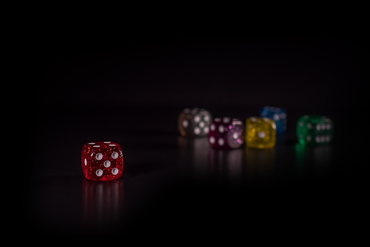 Responsible gambling an image of dice in a black room