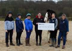 A cheque being handed over from Harbro to the RDA. Participants are Jamie, Ben and Mhairi; Alice Henderson, Harbro Stirling; Amanda Namey, Service Manager of Equi-Power Central Scotland RDA; Equi-Power Trustee Susan Dumbleton, RDA Participant Rep