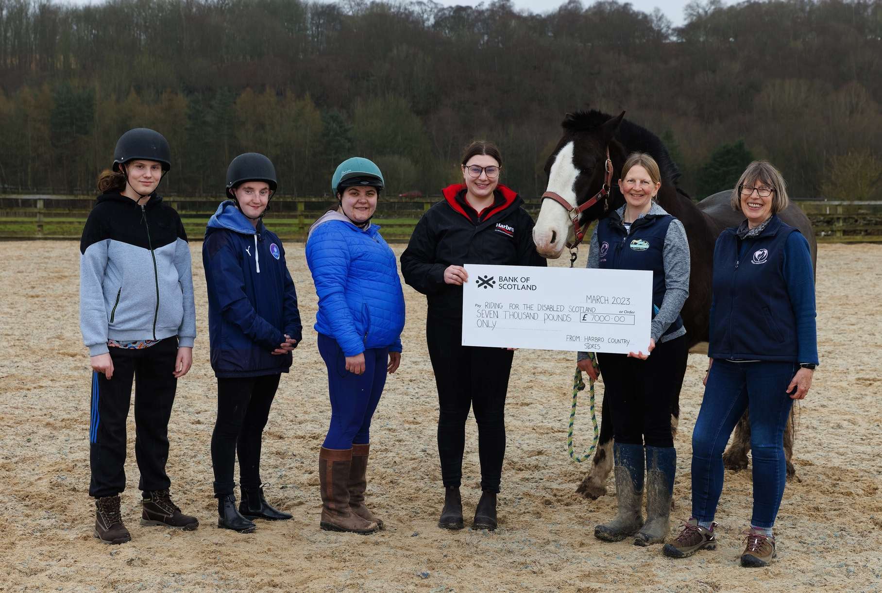 A cheque being handed over from Harbro to the RDA. Participants are Jamie, Ben and Mhairi; Alice Henderson, Harbro Stirling; Amanda Namey, Service Manager of Equi-Power Central Scotland RDA; Equi-Power Trustee Susan Dumbleton, RDA Participant Rep