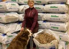 Mary King with HorseHage and a dog sat in feed room