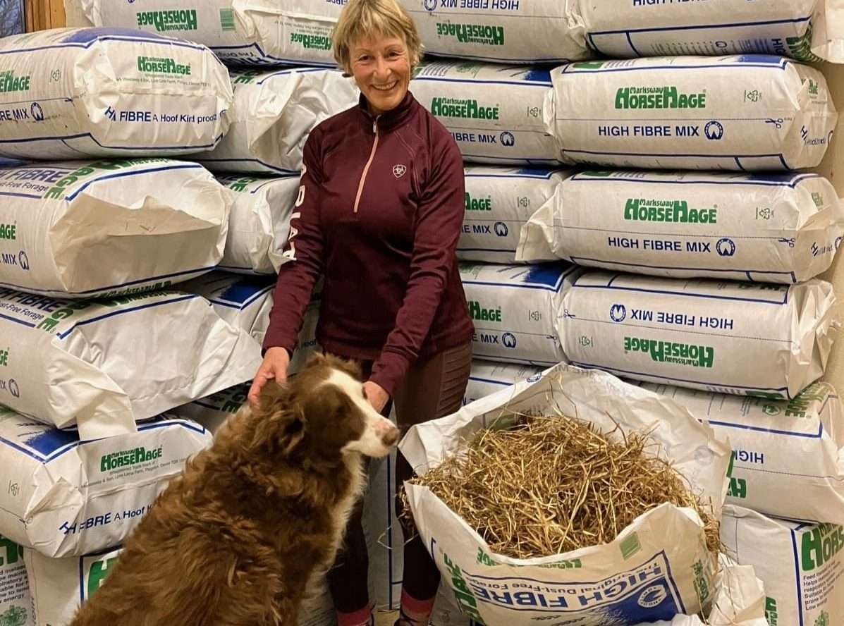 Mary King with HorseHage and a dog sat in feed room