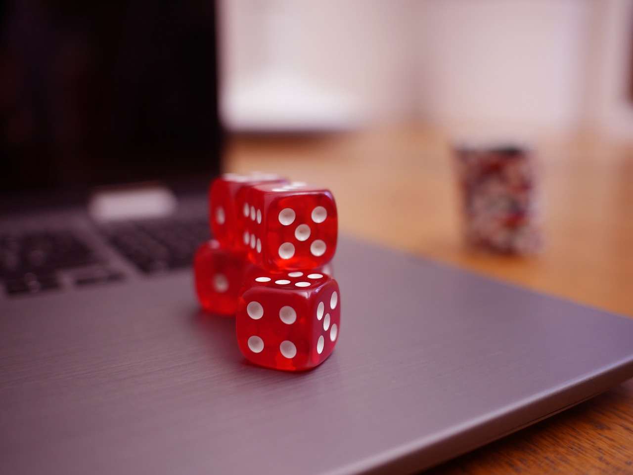 Betting on more than just horses: join the excitement in online casinos red dice on laptop