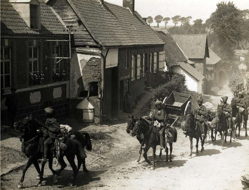 1914, World War 1. Indian cavalry marching through a French village. Photographer: H. D. Girdwood.