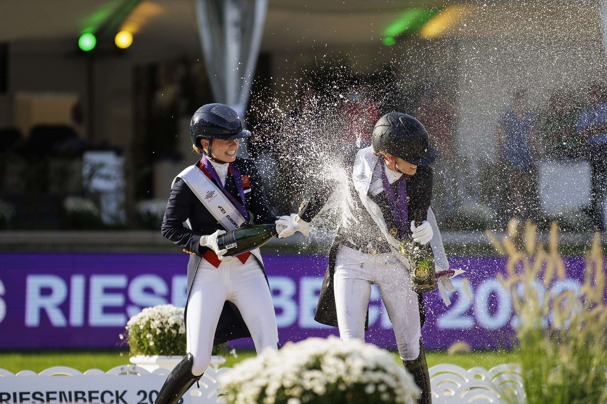 Jessica von Bredow Werndl (GER) and Charlotte Fry (GBR) during the award ceremony from the Grand Prix Freestyle at the FEI Dressage European Championship Riesenbeck 2023 Copyright ©FEI/Leanjo de Koster