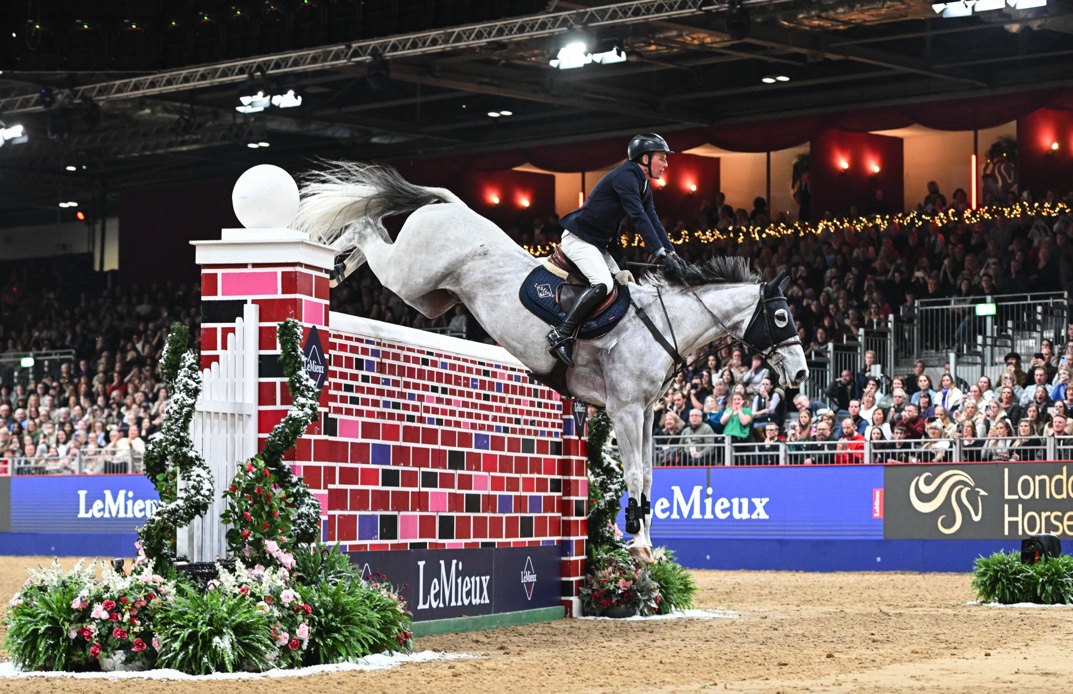 Guy Williams riding Mr Blue Sky UK, winners of The LeMieux Puissance at London International Horse Show @LondonInternationalHorseShow/Peter Nixon