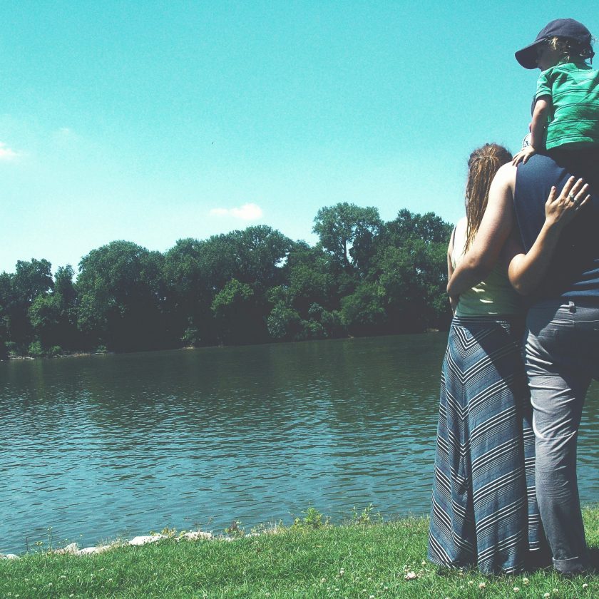 Best UK Attractions: Memorable Days for All Ages. Image of a family enjoying the countryside stood by a lake