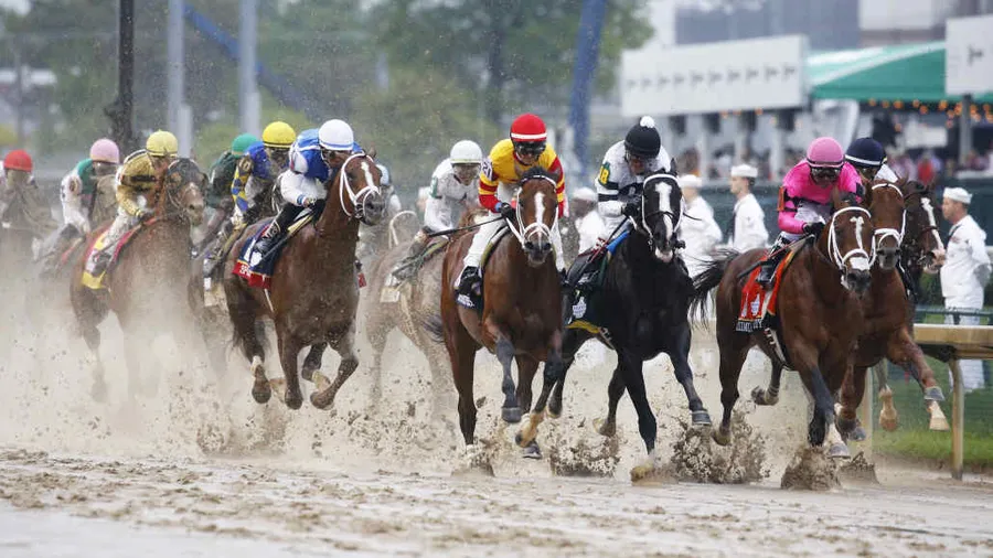 A Group Of Jockeys Racing In A Muddy Race Preakness Stakes