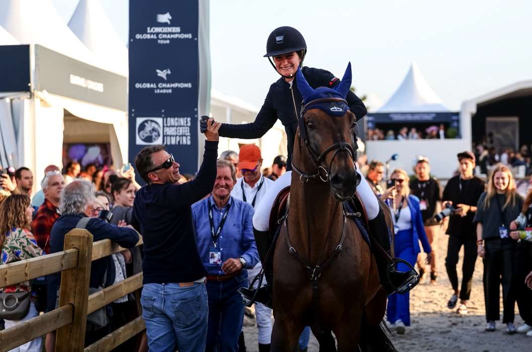 Jeanne Sadran  high fiving a team member after clinching her first ever CSI5* Grand Prix victory at the Longines Global Champions Tour Grand Prix of Paris 