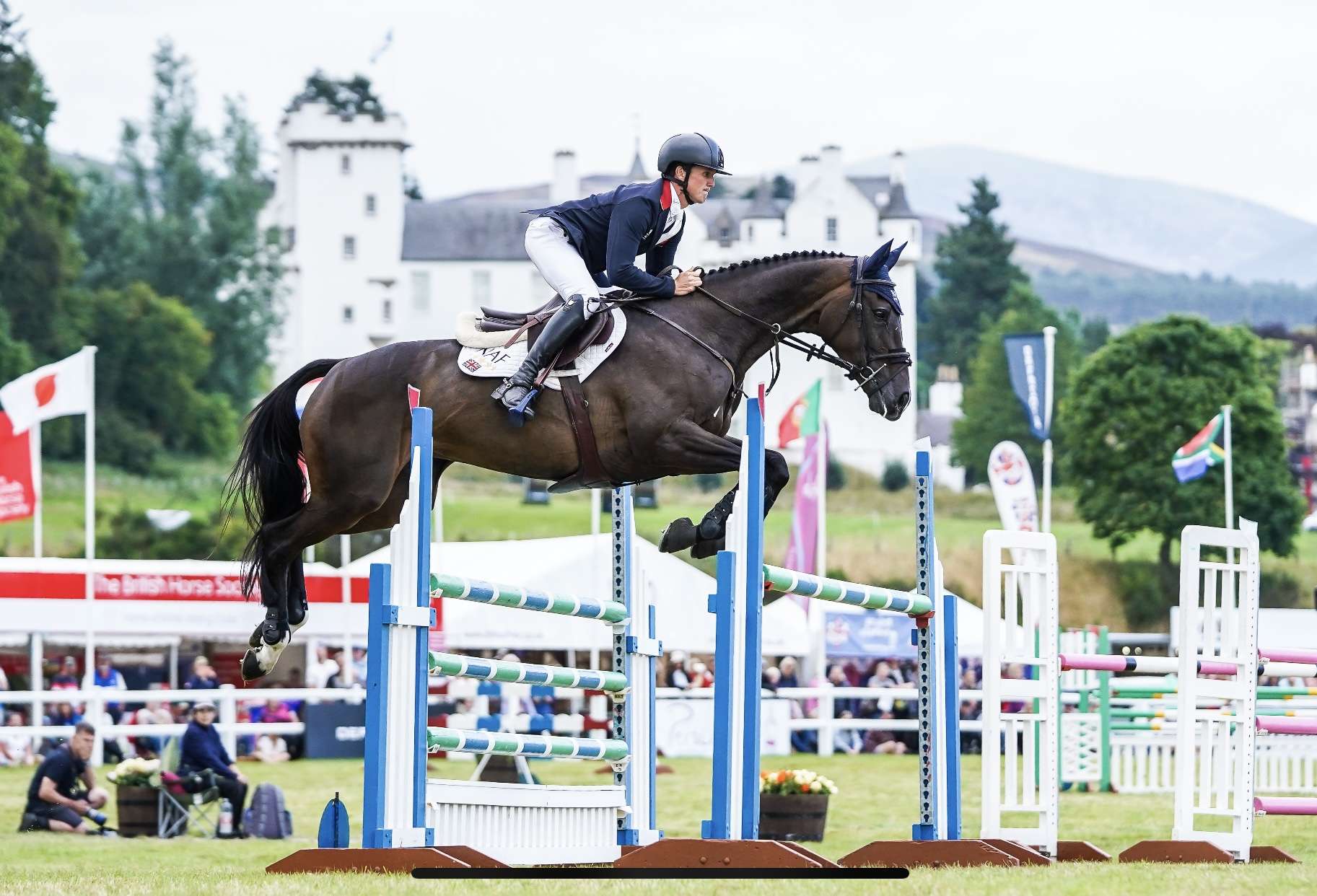 Blair Castle International Horse Trials man jumping a horse with castle in the backgroun
